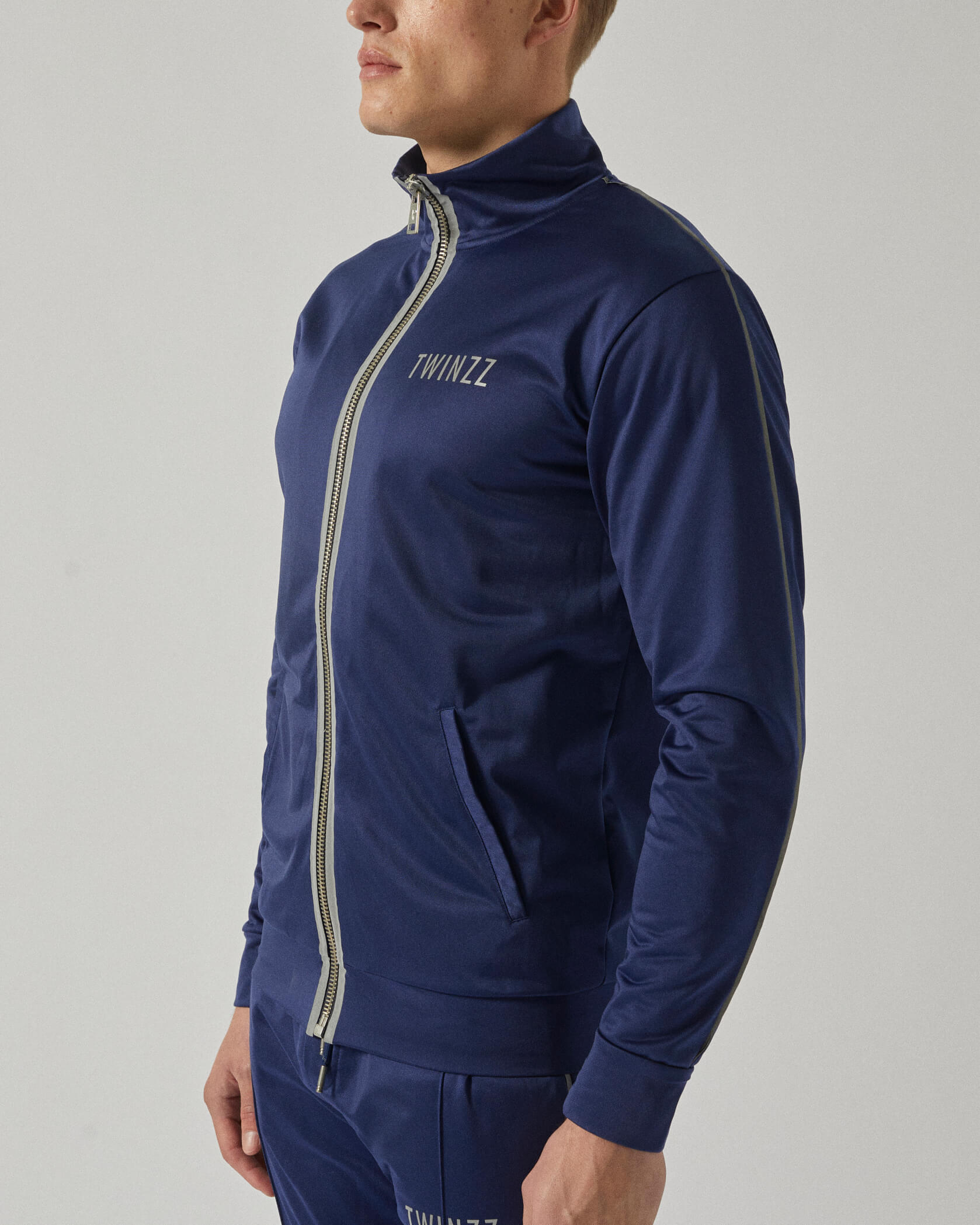 Twinzz Tech navy track jacket on model zipped up