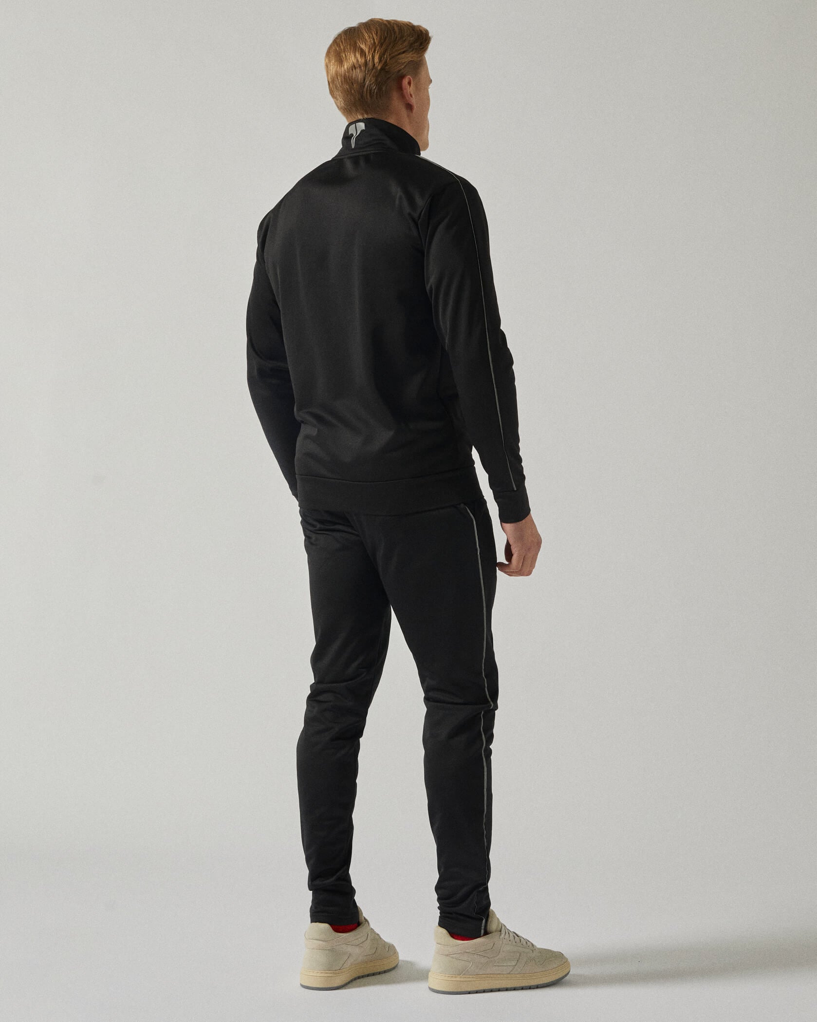Twinzz Tech black tracksuit on model from back